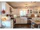 Bright and modern kitchen with granite countertops, stainless steel appliances and farm sink at 762 Thompson Ln, Loganville, GA 30052