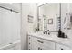 Modern bathroom featuring a white vanity, quartz countertop, and a walk-in shower with herringbone tile at 10235 Worthington Mnr, Suwanee, GA 30024