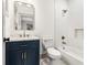 Charming bathroom with blue vanity, marble countertop, and white subway tile at 1055 Ormewood Se Ave, Atlanta, GA 30316