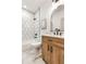 Bathroom featuring a hexagon-tiled shower, wood vanity, and modern fixtures for a clean aesthetic at 1055 Ormewood Se Ave, Atlanta, GA 30316
