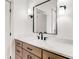 Bright bathroom with wood vanity, black fixtures, and modern mirror at 1055 Ormewood Se Ave, Atlanta, GA 30316
