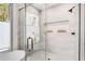 A luxurious bathroom features a glass-enclosed shower with marble tile, a built-in niche, and modern fixtures at 1055 Ormewood Se Ave, Atlanta, GA 30316