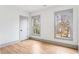 Bright bedroom with light hardwood floors, and two windows with exterior views at 1055 Ormewood Se Ave, Atlanta, GA 30316