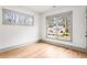 Bedroom featuring hardwood floors, white walls, and two windows with exterior views at 1055 Ormewood Se Ave, Atlanta, GA 30316