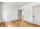 An empty bedroom with hardwood floors, white walls, two doors and grey trim at 1055 Ormewood Se Ave, Atlanta, GA 30316