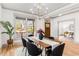 Stylish dining room with large window, modern lighting, and wood table, perfect for Gathering gatherings at 1055 Ormewood Se Ave, Atlanta, GA 30316