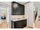 Attractive dry bar with marble countertops, black cabinets, and stylish hardware, near dining room at 1055 Ormewood Se Ave, Atlanta, GA 30316