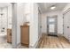 Hallway with view into bathroom with tile surround, cabinet, and view to back door at 1055 Ormewood Se Ave, Atlanta, GA 30316