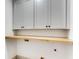 Functional laundry room features gray cabinets and wood countertop at 1055 Ormewood Se Ave, Atlanta, GA 30316