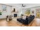 Bright living room with hardwood floors, fireplace, and a comfortable modern black sectional sofa at 1055 Ormewood Se Ave, Atlanta, GA 30316