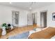 Bright main bedroom features an ensuite bathroom, hardwood floors, and modern neutral decor at 1055 Ormewood Se Ave, Atlanta, GA 30316