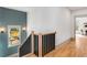 Elegant staircase with black railings and blue, decorative accent wall at 1055 Ormewood Se Ave, Atlanta, GA 30316