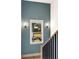 Striking staircase with paneled wall, black railings, wooden stairs, and bright window at 1055 Ormewood Se Ave, Atlanta, GA 30316