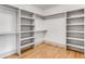 Spacious walk-in closet with custom shelving and wooden floors at 1055 Ormewood Se Ave, Atlanta, GA 30316