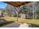Image showcasing a well-maintained backyard with a storage shed, mature trees, and a serene outdoor space at 1947 Phillips Lake Blf, Lithonia, GA 30058