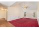 Spacious bedroom featuring a high vaulted ceiling, ceiling fan, a window, door to the deck and neutral walls at 1947 Phillips Lake Blf, Lithonia, GA 30058
