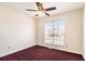 Well-lit bedroom featuring a ceiling fan and large window at 1947 Phillips Lake Blf, Lithonia, GA 30058
