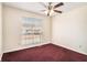 Bright bedroom featuring a ceiling fan and a large window at 1947 Phillips Lake Blf, Lithonia, GA 30058