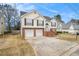 Charming two-story home with vinyl siding, brick foundation, and a two-car garage in a suburban neighborhood at 1947 Phillips Lake Blf, Lithonia, GA 30058