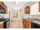 Eat-in kitchen featuring wood cabinets, granite countertops, stainless steel appliances and large windows at 1947 Phillips Lake Blf, Lithonia, GA 30058