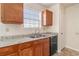 Close-up of kitchen featuring wood cabinets, granite countertops, stainless steel appliances and tile flooring at 1947 Phillips Lake Blf, Lithonia, GA 30058