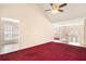 Bright living room with vaulted ceiling, ceiling fan, and an open doorway offering views to the entryway at 1947 Phillips Lake Blf, Lithonia, GA 30058