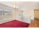 Bright living room features a large window, staircase with white railings, and views to the entryway at 1947 Phillips Lake Blf, Lithonia, GA 30058