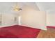 Bright living room featuring a vaulted ceiling, ceiling fan, and a door to the deck at 1947 Phillips Lake Blf, Lithonia, GA 30058