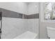 A luxurious tiled shower and mosaic accents adds to the appeal of this sleek bathroom at 5277 Cardinal Nw Ln, Lilburn, GA 30047