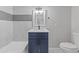 Modern bathroom features a navy blue vanity, updated fixtures, and tile accents at 5277 Cardinal Nw Ln, Lilburn, GA 30047
