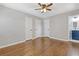 Bright bedroom featuring hardwood floors, three closets, and an ensuite bathroom at 5277 Cardinal Nw Ln, Lilburn, GA 30047