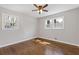 Bright bedroom with two windows, hardwood floors, and neutral paint at 5277 Cardinal Nw Ln, Lilburn, GA 30047