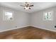 The bedroom features hardwood floors, neutral paint, and large windows that bring in natural light at 5277 Cardinal Nw Ln, Lilburn, GA 30047