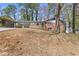 Exterior of home with a large front yard, carport, and covered front porch at 5277 Cardinal Nw Ln, Lilburn, GA 30047