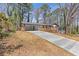 View of a well-maintained home, showcasing its covered parking and inviting front porch at 5277 Cardinal Nw Ln, Lilburn, GA 30047