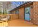 Exterior view of home from the deck, featuring a blue door and brick at 5277 Cardinal Nw Ln, Lilburn, GA 30047