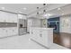 Kitchen and living area with stainless appliances, island and statement blue brick fireplace at 5277 Cardinal Nw Ln, Lilburn, GA 30047