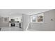 White kitchen features stainless steel appliances, tile flooring and natural light at 5277 Cardinal Nw Ln, Lilburn, GA 30047
