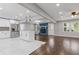 Open-concept kitchen featuring white cabinets, stainless steel appliances, and a cozy living area at 5277 Cardinal Nw Ln, Lilburn, GA 30047