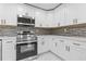 Kitchen featuring sleek appliances, white countertops, and ample cabinet space at 5277 Cardinal Nw Ln, Lilburn, GA 30047