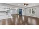 Open-concept living space with hardwood floors, a fireplace, and an adjacent modern kitchen at 5277 Cardinal Nw Ln, Lilburn, GA 30047