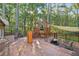 Large wooden deck features an outdoor seating area, a fire pit, and an elevated swing at 80 Rountree Rd, Riverdale, GA 30274