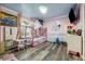 Adorable pink bedroom featuring a princess castle mural, canopy bed, and playful decor at 80 Rountree Rd, Riverdale, GA 30274