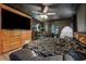 Bedroom featuring black walls, wood-look floors, comfy furniture and decorative shelves at 80 Rountree Rd, Riverdale, GA 30274