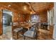 Warm dining room featuring wood walls, hardwood floors, and a large dining table at 80 Rountree Rd, Riverdale, GA 30274