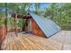 Unique A-frame cabin with a wooden deck, set amidst a serene wooded environment, offering a peaceful getaway at 80 Rountree Rd, Riverdale, GA 30274