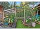 View of the garden featuring a wooden structure, artificial turf, and various vegetation at 80 Rountree Rd, Riverdale, GA 30274