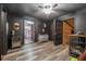 Hallway with black walls and doors that leads to an open doorway and a room that leads to an attic space at 80 Rountree Rd, Riverdale, GA 30274