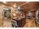 Charming kitchen showcasing wood paneling, central island, and adjacent dining space at 80 Rountree Rd, Riverdale, GA 30274