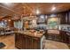 Gourmet kitchen boasting custom cabinetry, wood countertops, copper sink, and island with cooktop at 80 Rountree Rd, Riverdale, GA 30274